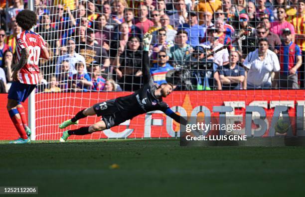 Atletico Madrid's Slovenian goalkeeper Jan Oblak fails to stop a goal by Barcelona's Spanish forward Ferran Torres during the Spanish league football...