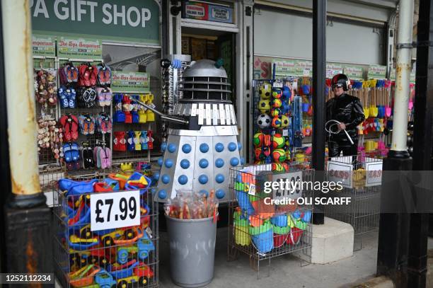 Cosplayers dressed as sci-fi characters pass a seaside gift shop as they return to the venue hosting Sci Fi Scarborough at The Spa Complex in...