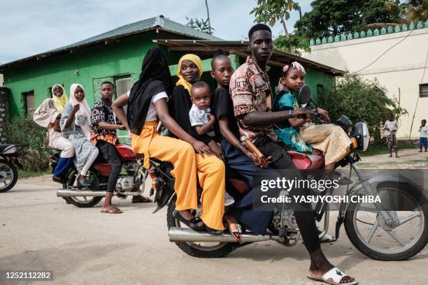 Muslim worshippers take a motorbike taxi to go to beach for the celebration of Eid al-Fitr, which marks the end of the holy fasting month of Ramadan,...