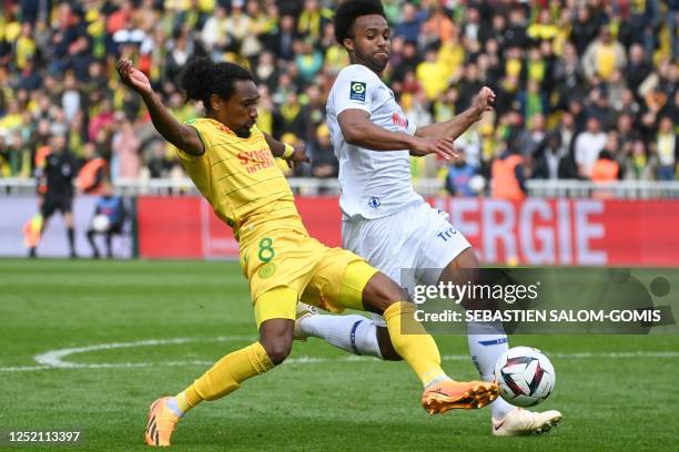 Nantes' French midfielder Samuel Moutoussamy fights for the ball with Troyes' US defender Erik Palmer-Brown during the French L1 football match...