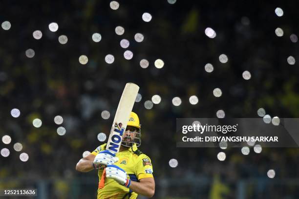 Chennai Super Kings' captain Mahendra Singh Dhoni watches the ball after playing a shot during the Indian Premier League Twenty20 cricket match...