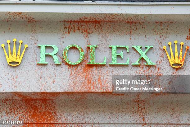 Orange paint sprayed by activists from the "Last Generation" climate action movement on a ROLEX shop on the famous shopping avenue of Kurfürstendamm...