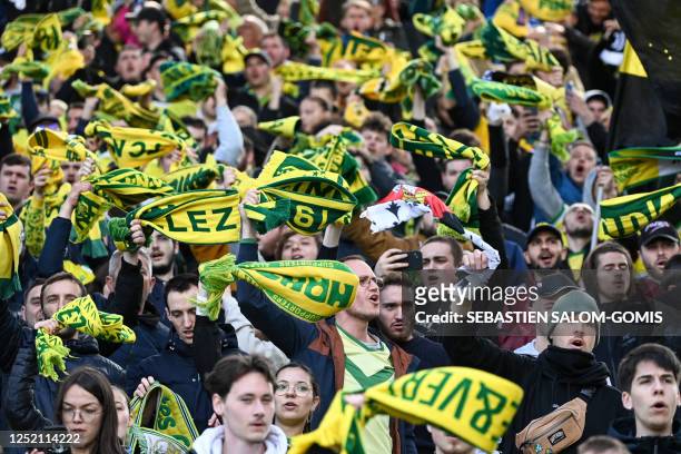 Nantes' supporters hold their scarfs during the French L1 football match between FC Nantes and ES Troyes AC at the Stade de la BeaujoireLouis...