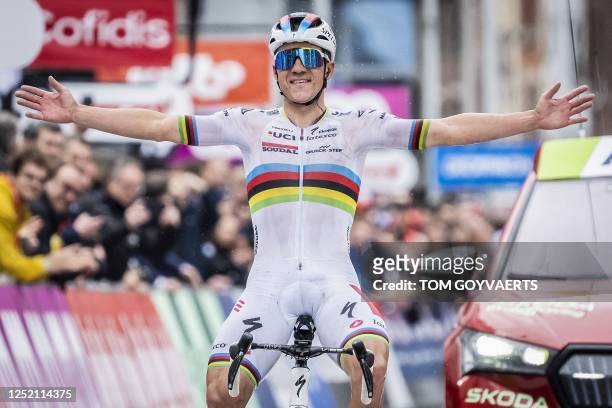 Soudal Quick-Step's Belgian rider Remco Evenepoel celebrates as he cycles to the finish line to win the men's elite race of the Liege-Bastogne-Liege...