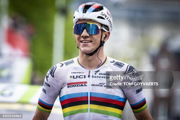 Soudal Quick-Step's Belgian rider Remco Evenepoel celebrates as he crosses the finish line to win the men's elite race of the Liege-Bastogne-Liege...