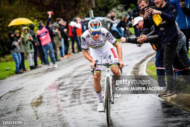 Soudal Quick-Step's Belgian rider Remco Evenepoel is cheered by supporters as he rides before winnig the men's elite race of the Liege-Bastogne-Liege...