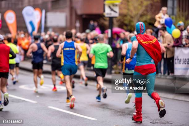 Runners compete with different costumes during the London Marathon in London, United Kingdom on April 23, 2023.