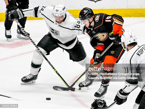 Vladislav Gavrikov of the Kings and Troy Terry of the Ducks battle for the puck in the second period in a game at the Honda Center in Anaheim on...