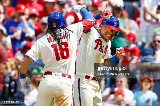 Brandon Marsh of the Philadelphia Phillies is congratulated by Cristian Pache after he hit a two-run home run against the Colorado Rockies during the...