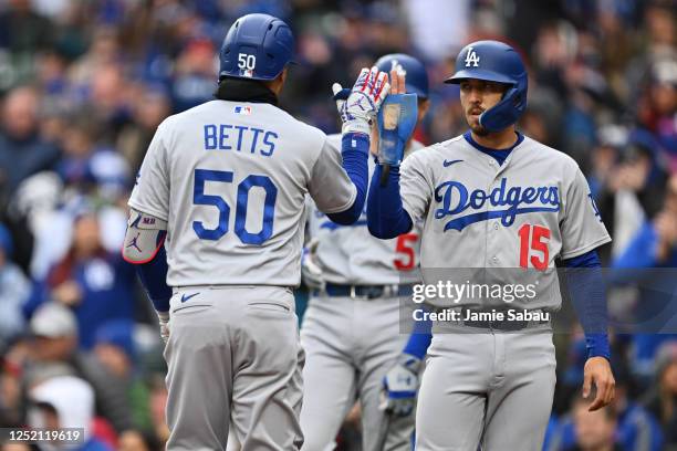 Mookie Betts of the Los Angeles Dodgers is congratulated by Austin Barnes after hitting a two-run home run in the third inning against the Chicago...