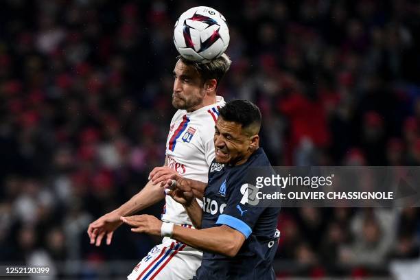 Lyon's Argentinian defender Nicolas Tagliafico fights for the ball with Marseille's Chilean forward Alexis Sanchez during the French L1 football...