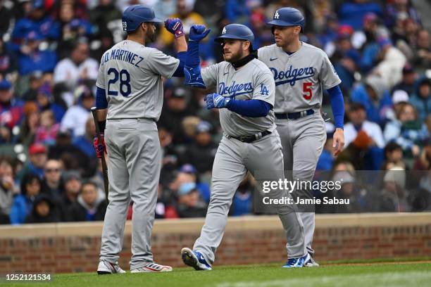 Max Muncy of the Los Angeles Dodgers is congratulated by J.D. Martinez after hitting a two-run home run with Freddie Freeman on base in the fifth...