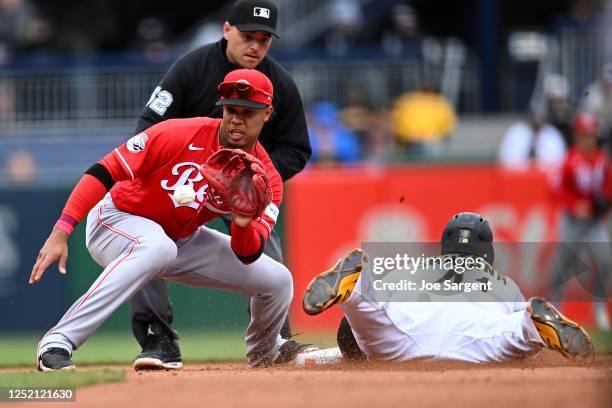 Carlos Santana of the Pittsburgh Pirates safely steals second base in front of Jose Barrero of the Cincinnati Reds at PNC Park on April 23, 2023 in...