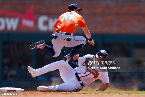 Matt Olson of the Atlanta Braves is out at second as Mauricio Dubon of the Houston Astros throws to first during the sixth inning at Truist Park on...