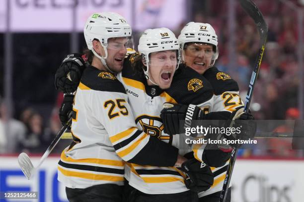 Boston Bruins left wing Tyler Bertuzzi celebrates a goal in the third period with Boston Bruins defenseman Hampus Lindholm and Boston Bruins...