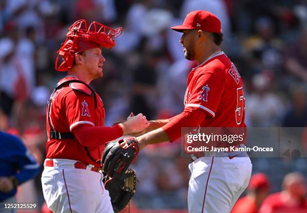 Carlos Estevez is congratulated by catcher Chad Wallach of the Los Angeles Angels after a save in the ninth inning against the Kansas City Royals at...