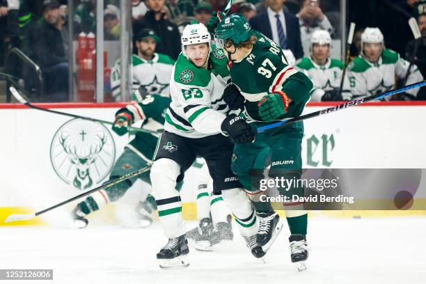 Esa Lindell of the Dallas Stars checks Kirill Kaprizov of the Minnesota Wild in the first period of Game Four of the First Round of the 2023 Stanley...