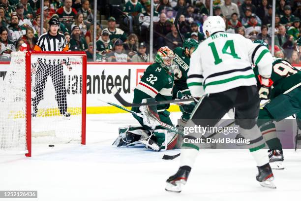 Puck shot by Tyler Seguin of the Dallas Stars goes past Filip Gustavsson of the Minnesota Wild for a power-play goal in the second period of Game...