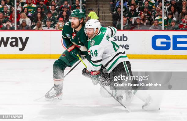 Marcus Foligno of the Minnesota Wild fights for position with Joel Hanley of the Dallas Stars in the second period of Game Four of the First Round of...