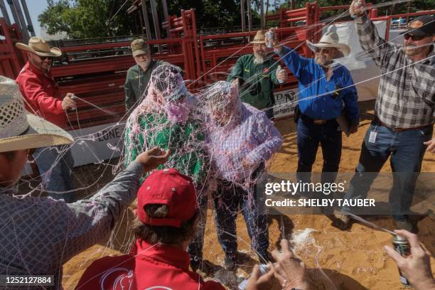 International Gay Rodeo Association members and rodeo workers celebrate Nicole Reighlie, who was just certified as a chute coordinator, and Barbara...