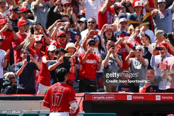 Fans cheer for Los Angeles Angels designated hitter Shohei Ohtani after hitting a solo home run in the sixth inning during a regular season game...