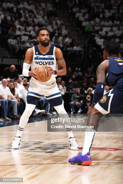 Mike Conley of the Minnesota Timberwolves looks to pass the ball during Round 1 Game 4 of the 2023 NBA Playoffs against the Denver Nuggets on April...
