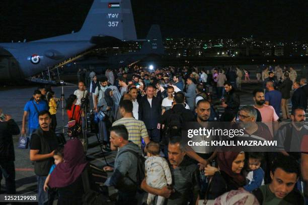 People evacuated from Sudan arrive at a military airport in Amman on April 24, 2023. Foreign countries rushed to evacuate their nationals from Sudan...