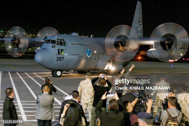 Jordanian military aircraft carrying people evacuated from Sudan arrives at an airport in Amman on April 24, 2023. Foreign countries rushed to...