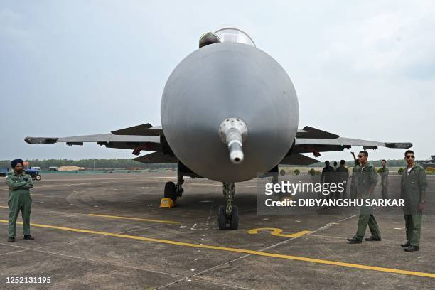Indian Air Force personnel stand next to a Sukhoi Su-30 fighter jet during the joint 'Exercise Cope India 2023' between the United States Air Force...