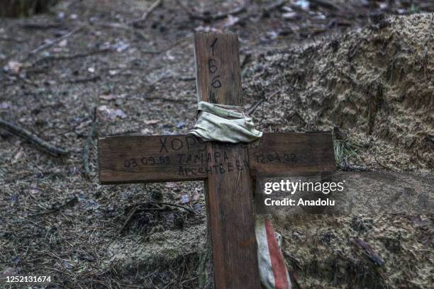 April 22: A cross is seen at a forest grave site after an exhumation in the town of Izium, recently liberated by Ukrainian forces on April 22, 2023...