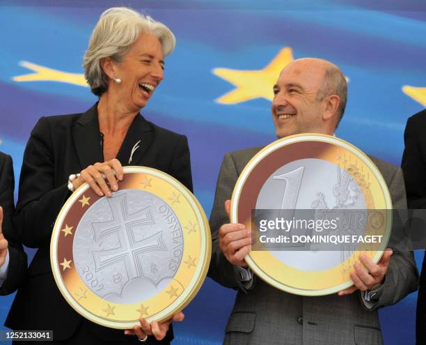 French Finance Minister Christine Lagarde and EU economic and monetary affairs commissioner Joaquin Almunia pose with a Slovakian Euro on July 8,...