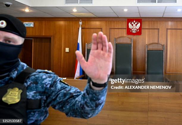 Court bailiff gestures before an appeal hearing for Darya Trepova, charged with terrorism over the April 2 bomb blast in a cafe in Saint Petersburg...