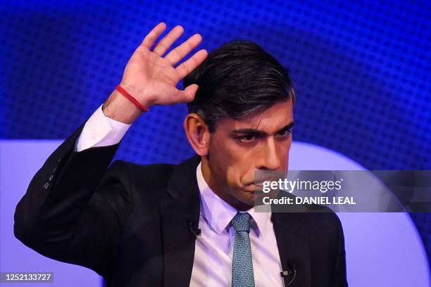 Britain's Prime Minister Rishi Sunak reacts as he waves to the audience at the end of his speech during the Business Connect event in North London,...