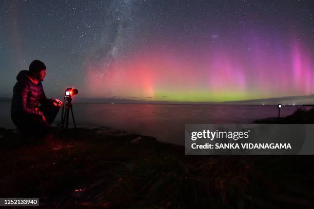 Photographer takes pictures of the Aurora Australis, also known as the Southern Lights, as it glows on the horizon over waters of Lake Ellesmere on...