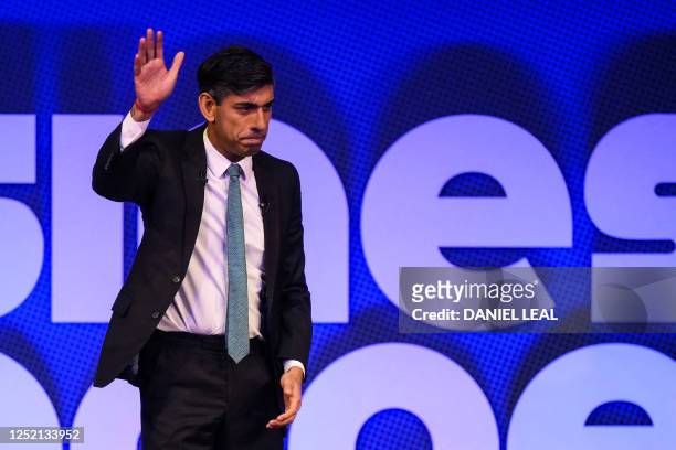 Britain's Prime Minister Rishi Sunak reacts as he waves to the audience at the end of his speech during the Business Connect event in North London,...