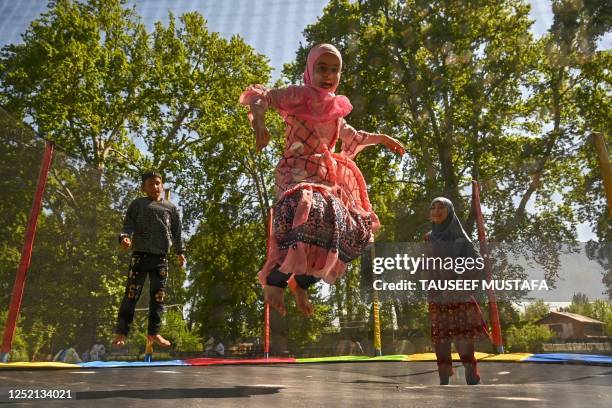 Children play on a trampoline in Srinagar on April 24, 2023.