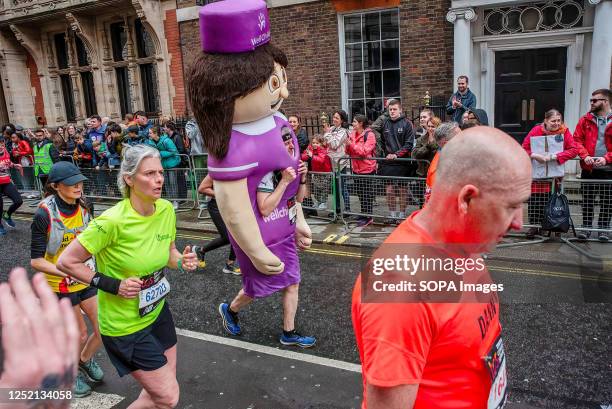 Man dressed as a nurse from the Wellchild charity seen during the London Marathon. 42nd London Marathon was held in London. First was in 1981....
