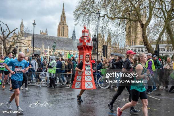 Man dressed as a tower seen during the London Marathon. Meantime there are the towers of the Parliament at the background. 42nd London Marathon was...