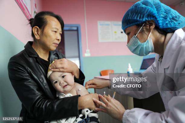 Medical worker inoculates children with the BCG vaccine in Chongqing, China, April 24, 2023.