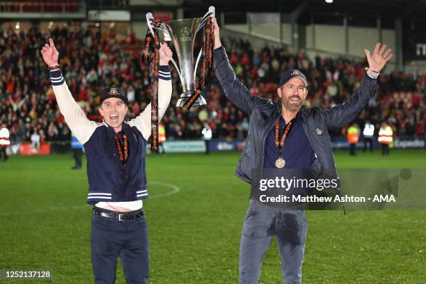 Wrexham owners Rob McElhenney and Ryan Reynolds hold the Vanarama National League Trophy as Wrexham celebrate promotion back to the English Football...