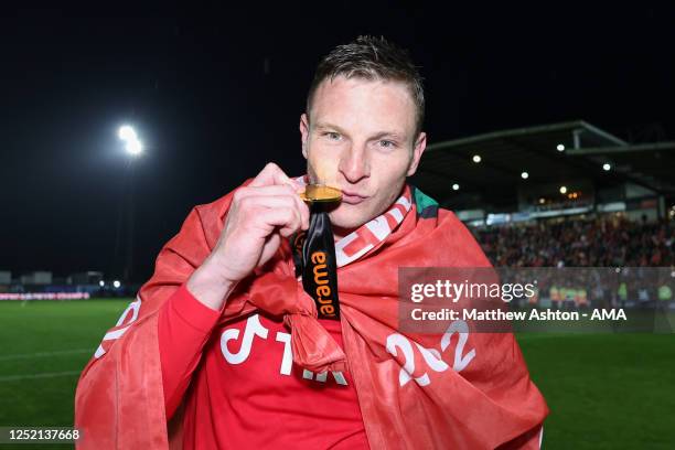 Paul Mullin of Wrexham kisses his champions winner medal as Wrexham celebrate promotion back to the English Football League during the Vanarama...