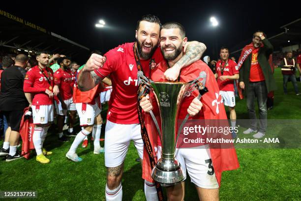 Ollie Palmer and Elliot Lee of Wrexham hold the Vanarama National League trophy as Wrexham celebrate promotion back to the English Football League...