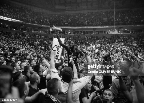 Partizan's French player Mathias Lessort celebrates their victory with fans after the EuroLeague basketball match between KK Partizan Belgrade and...