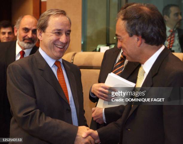 Finance Minister of Greece Georgios Alogoskoufis greets New Finance Minister of Cyprus Charilaos Stavrakis before a Eurogroup council on March 3,...