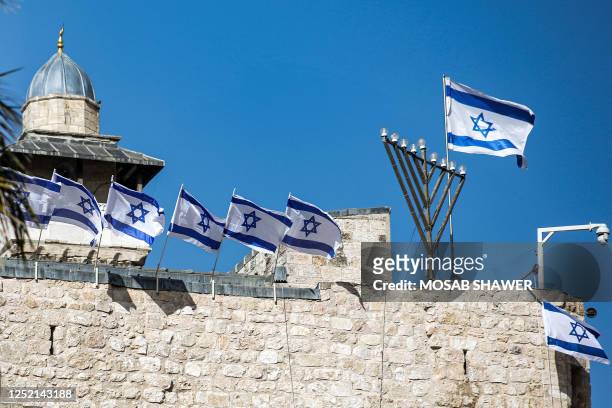 Israeli flags are placed atop the walls of the Ibrahimi mosque, also known to Jews as the Tomb of the Patriarchs, believed to be the final resting...