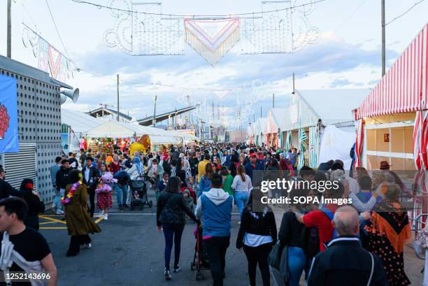 People are seen walking among the stalls during the celebrations for the "Feria de Abril" fair in Forum Park. The fair, known as Seville Fair, is...