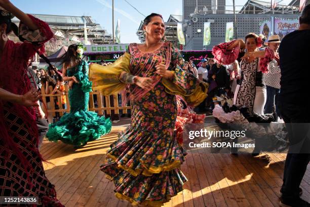 Women wearing typical Sevillian costumes , dance the Sevillanas during the 50th anniversary of the April Fair in Barcelona. Thousands of people...