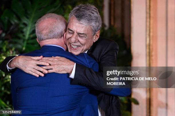 Brazilian President Luiz Inacio Lula da Silva greets Brazilian singer and songwriter Chico Buarque at the end of his speech during the Camoes...