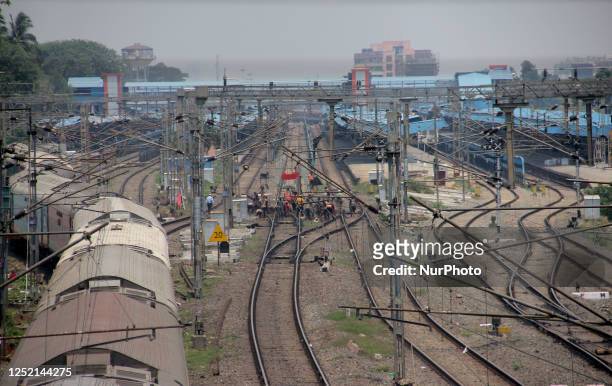 Laborers are seen as they are busy in the railway track repairing works just approach point of the city railway station of the eastern Indian state...