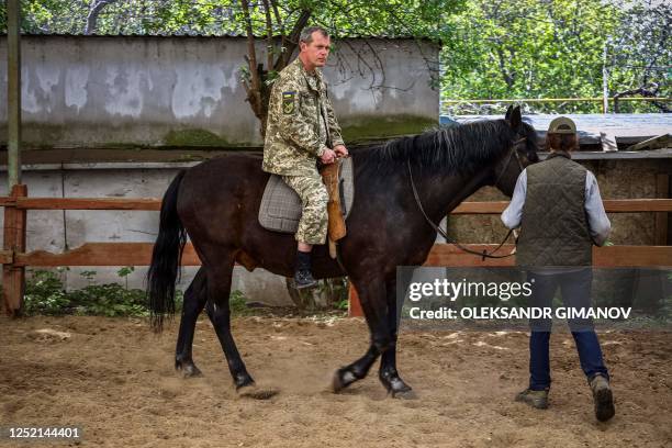 Ukrainian serviceman rides a horse during a hippotherapy session in Odesa on April 24 amid the Russian invasion of Ukraine. - In the Black Sea port...
